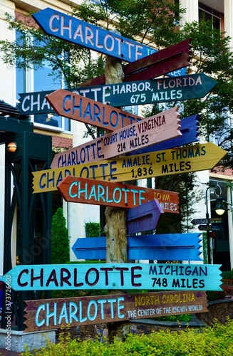Colorful wooden street signs in Charlotte, North Carolina, indicating ways to all over the world