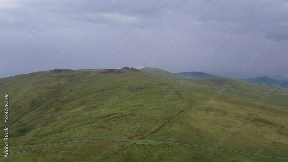 Aerial view of a green hilly area in the English Lake District, bright but overcast day. Aerial view of a green hilly area in the English Lake District, bright but overcast day.