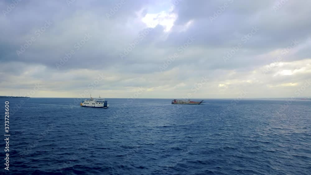 Two Ships Floating on The Open Sea During The Day Two Ships Floating on The Open Sea During The Day