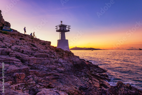 Mount Johnston Lighthouse at Ap Lei Pai beaming light ray in marine at night