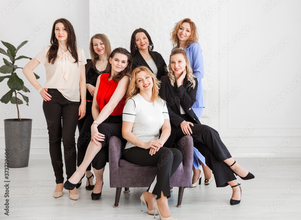 Fototapeta premium Happy women work team employees group looking at camera posing in studio, smiling women company staff workers, workforce members, business people managers standing together, portrait.
