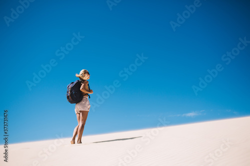 Woman walking on sand in desert