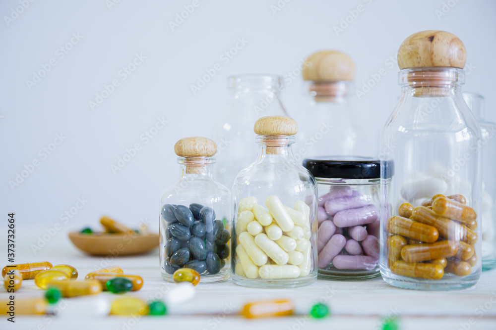 Set of medicine bottles and medicine pills on wooden table. Pharmaceutical medicament. Dietary supplements, drugs, Pharmacy, Medicine and healthcare concept. With copy space