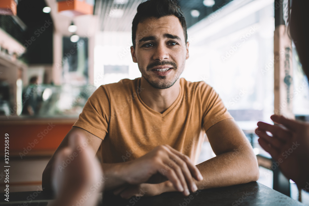 Positive guy discussing startup with colleague at workplace Positive guy discussing startup with colleague at workplace