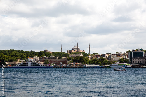 Panoramic shot of the old town Istanbul; The Hagia Sophia (Ayasofya) Mosque Eminonu, ferries and boats on the Golden Horn, Istanbul, Turkey.