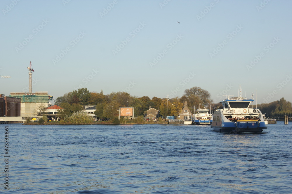 Ferries riding the waves on Amsterdam IJ Ferries riding the waves on Amsterdam IJ