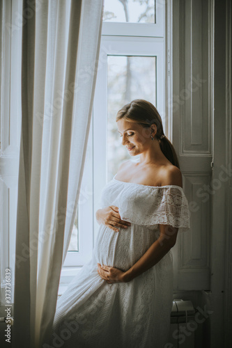 Pretty young pregnant woman...