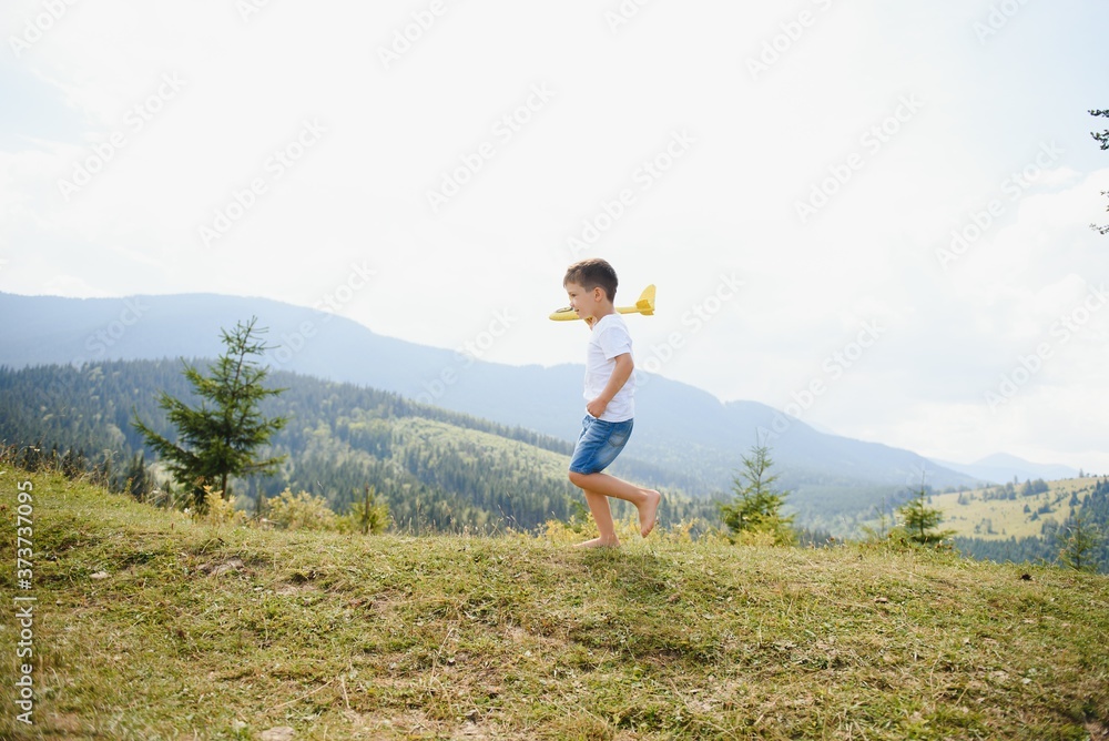 Child pilot aviator with airplane dreams of traveling in summer in nature. Child pilot aviator with airplane dreams of traveling in summer in nature.