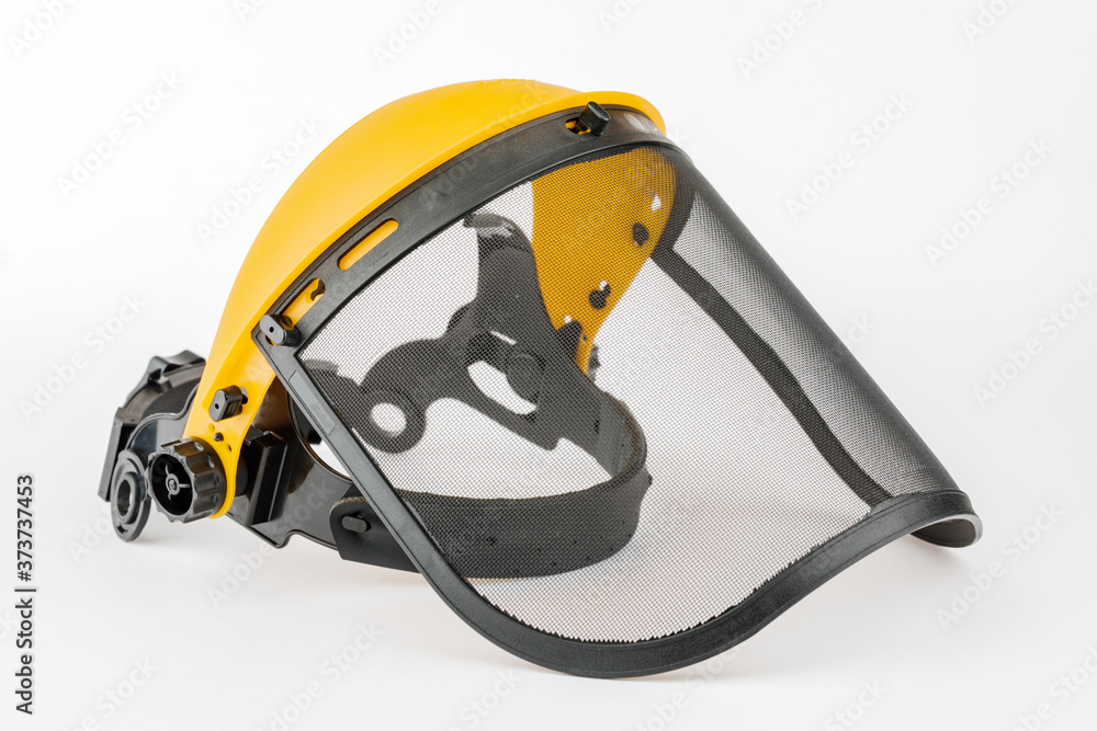 Naklejka premium Yellow construction mask-grid on a wooden table on a white background.