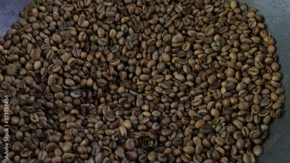 Roasting coffee beans by hand . Roasting coffee beans by hand .