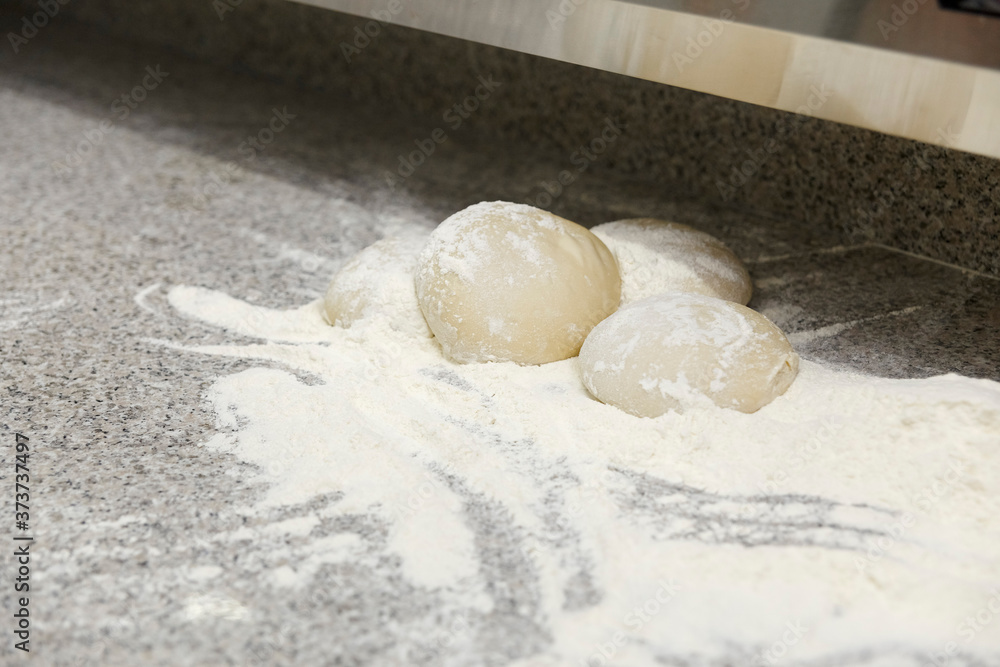 Close up of powdered white dough for cooking pizza. Close up of powdered white dough for cooking pizza.