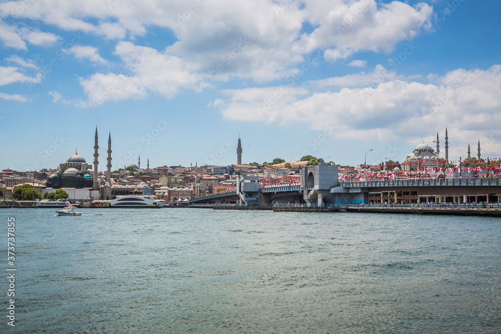 The old town of Istanbul showing the Golden Horn Bridge (Halic koprusu), The Yeni Mosque, The Beyazit Tower, the Suleymaniye Mosque, ferries and boats on the Golden Horn.