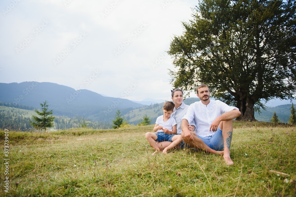 Young family with child resting on a mountain. vacation in the national park Young family with child resting on a mountain. vacation in the national park