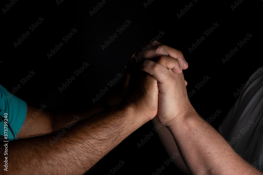 Detail of interracial gay couple holding hands