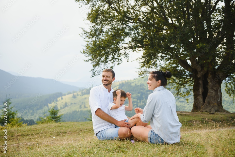 Young family with child resting on a mountain. vacation in the national park Young family with child resting on a mountain. vacation in the national park