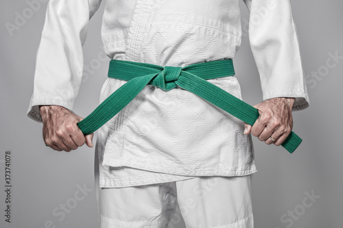 martial arts practitioner tightening his belt