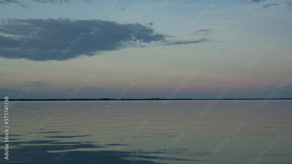 Fototapeta premium single cloud over reflective calm lake