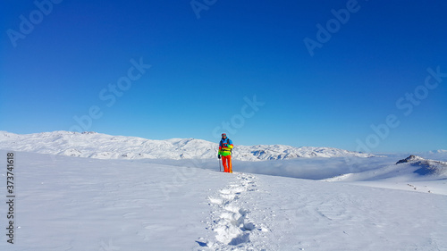 A skier and mountaineer in the snowy mountains, winter season 
