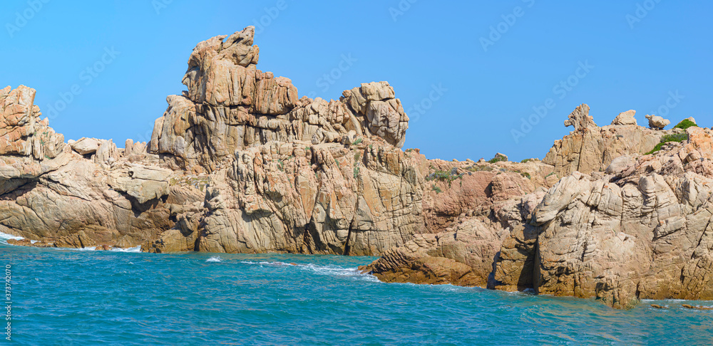 Beautiful shot of rock formations near the sea close to Beach Li Cossi, Sardinia, Italy.
