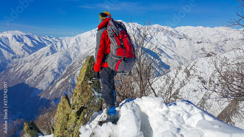 A skier and mountaineer in the snowy mountains, winter season 