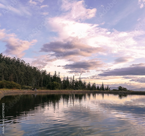 Reflected lake and trees landscape, sunset