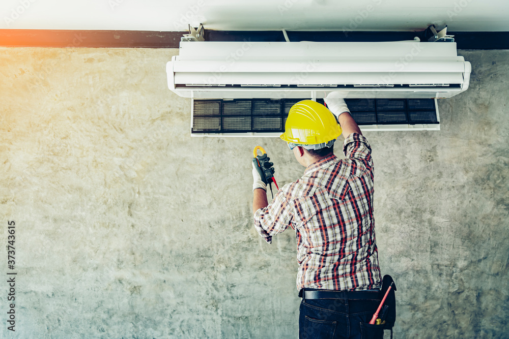 Fototapeta premium Technician - Engineer investigate Repairing Air Conditioner