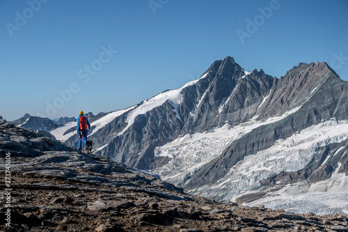 Hiker with dog in the Alps