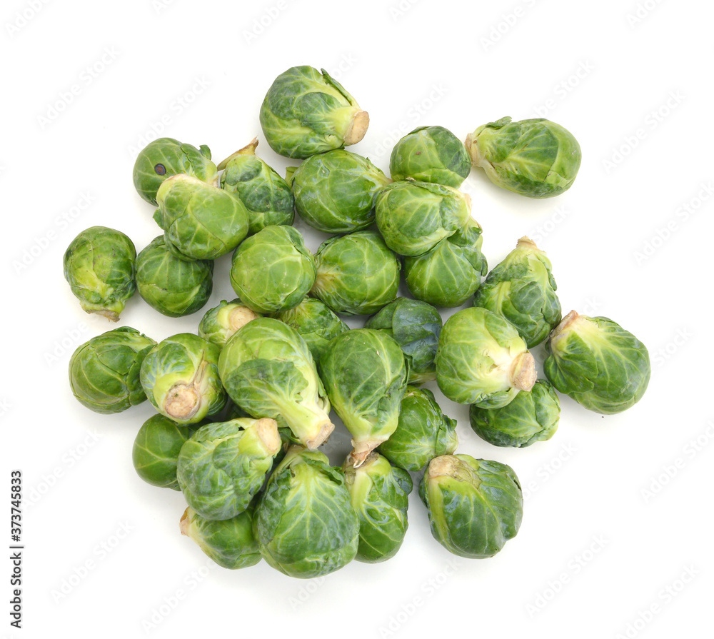 freshly brussel sprouts and some whole ones on a white background freshly brussel sprouts and some whole ones on a white background