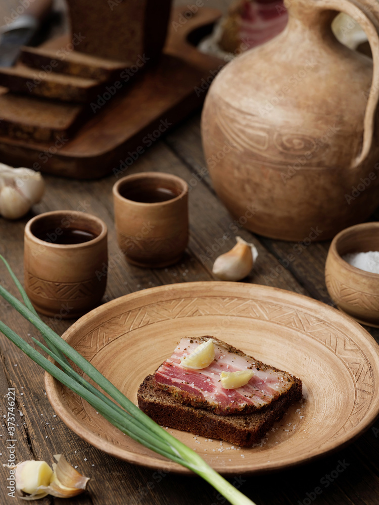 Sandwich with lard on a wooden background