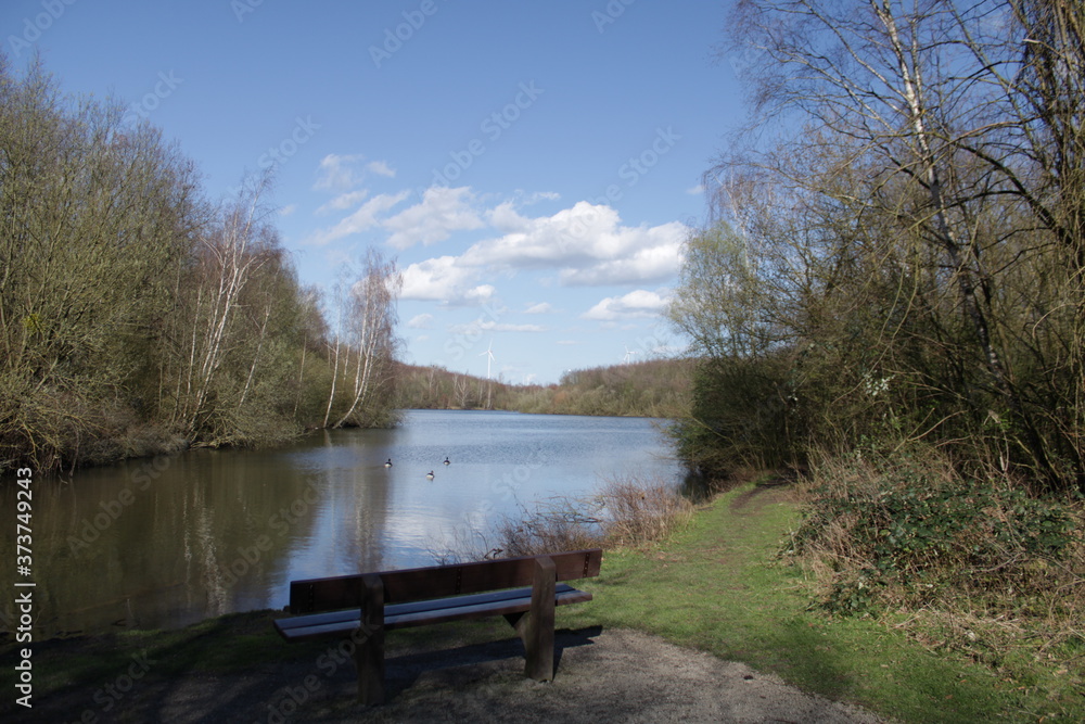 A park bench in the foreground of a lake

