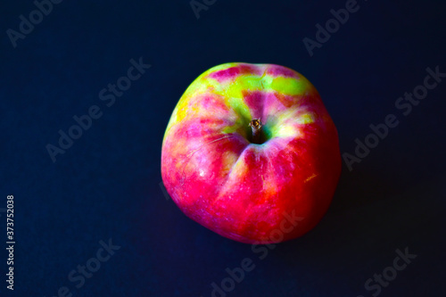 Red yellow ripe Apple on a black background