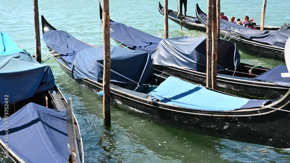 Venice, Italy - gondolas and gondoliers in the Grand Canal near the Rialto Bridge, in the San Marco Basin and between the canals of the lagoon city Venice, Italy - gondolas and gondoliers in the Grand Canal near the Rialto Bridge, in the San Marco Basin and between the canals of the lagoon city
