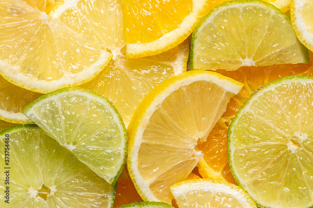 Juicy aromatic background made with slices of different citrus fruits such as limes, lemons and oranges. Juicy aromatic background made with slices of different citrus fruits such as limes, lemons and oranges.