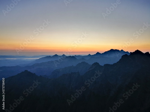 The contours of the mountain peaks at sunrise. Mountain peaks at sunrise. Tatra Mountains Poland. © Tomek