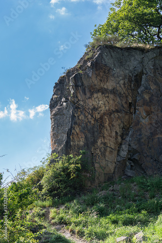 A rock wall of the Stenzelberg against the blue sky.