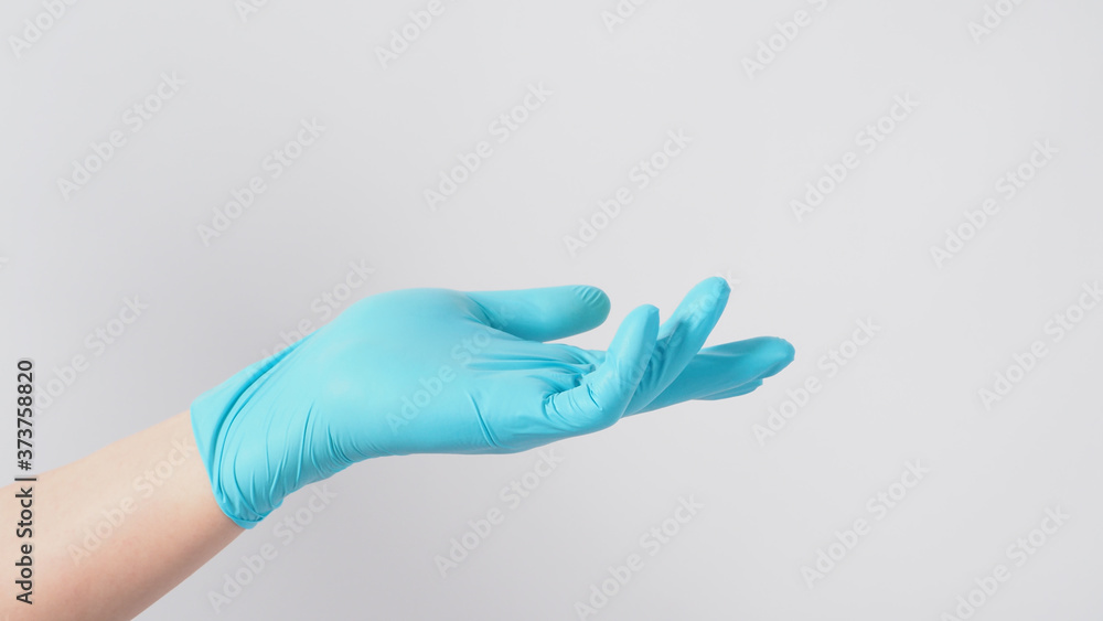 Empty hand with blue latex glove on white background.