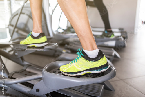 detail of legs training on elliptical trainer