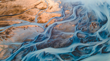 A glacial rivers from above. Aerial photograph of the river streams from Icelandic glaciers. Beautiful art of the Mother nature created in Iceland. Wallpaper background high quality photo
