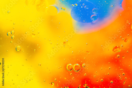 Abstract colorful Background Oil in Water with colorful gradient colors. Fantastic structure of colorful oil bubbles. Chaotic motion. Psychedelic pattern image rainbow colored. Macro shot