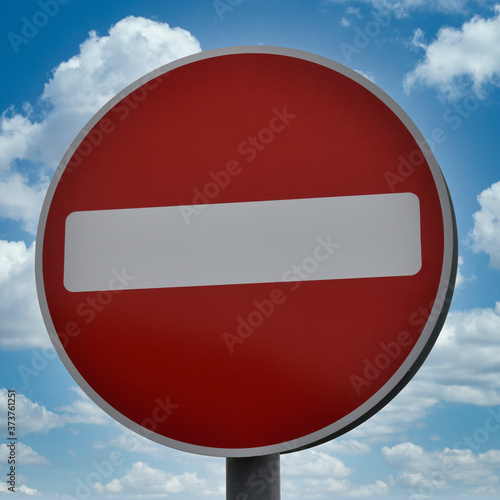 Free Download Circular red and white no entry sign UK, isolated with blue sky and clouds background. - GFXLoad