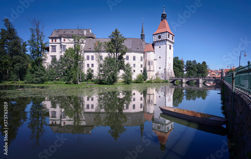 Photograph of Blatna Castle, its reflection in the lake and a small boat. © jcserrano