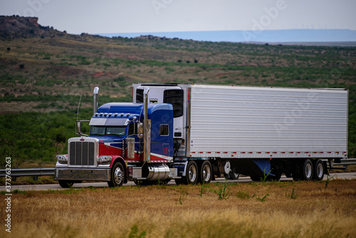 Arizona, USA - May, 2020: American truck. American style truck on freeway pulling load. Transportation theme. Road cars theme.