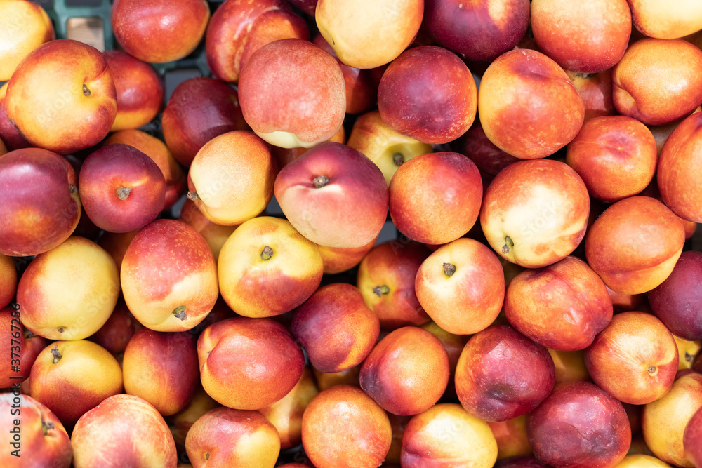 background of red peachs on sale at the local market background of red peachs on sale at the local market