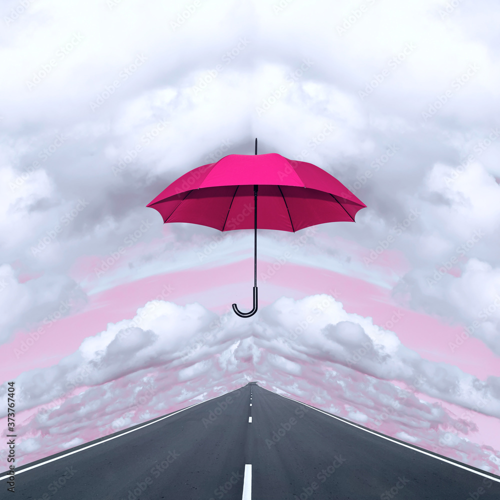 Contemporary collage. Red umbrella against the background of the road and sky with clouds.