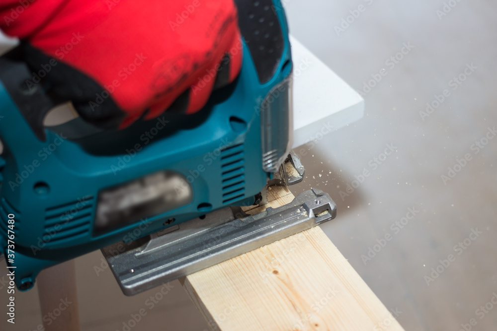 Power tool for home repair. Image of electric fretsaw in action. Power tool for home repair. Image of electric fretsaw in action.