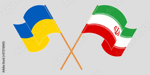 Crossed and waving flags of Iran and the Ukraine