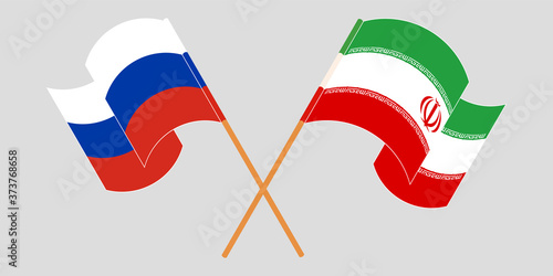 Crossed and waving flags of Iran and Russia