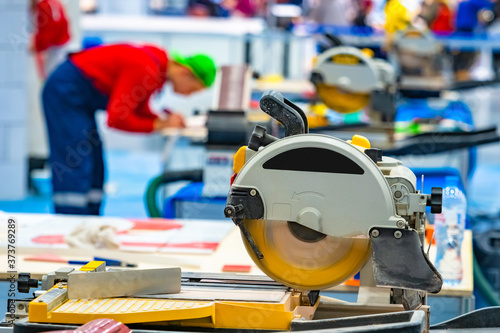 Yellow circular saw on ston...