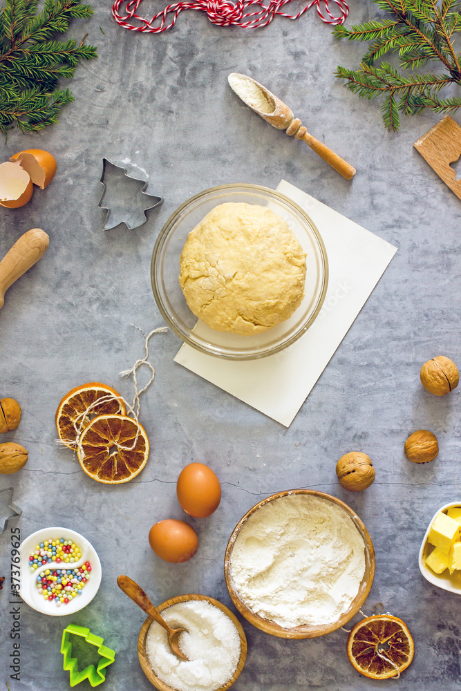 Christmas cookie recipe step. Step six. Shortbread dough. Ingredients for cooking flour, sugar, eggs, butter, spices, nuts, top view, flat lay Christmas cookie recipe step. Step six. Shortbread dough. Ingredients for cooking flour, sugar, eggs, butter, spices, nuts, top view, flat lay