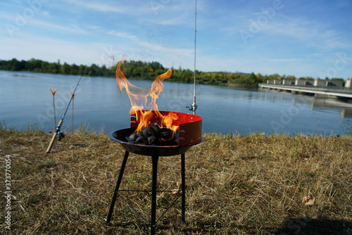 Billede på lærred Charcoal grill in the lakeshore during the daytime